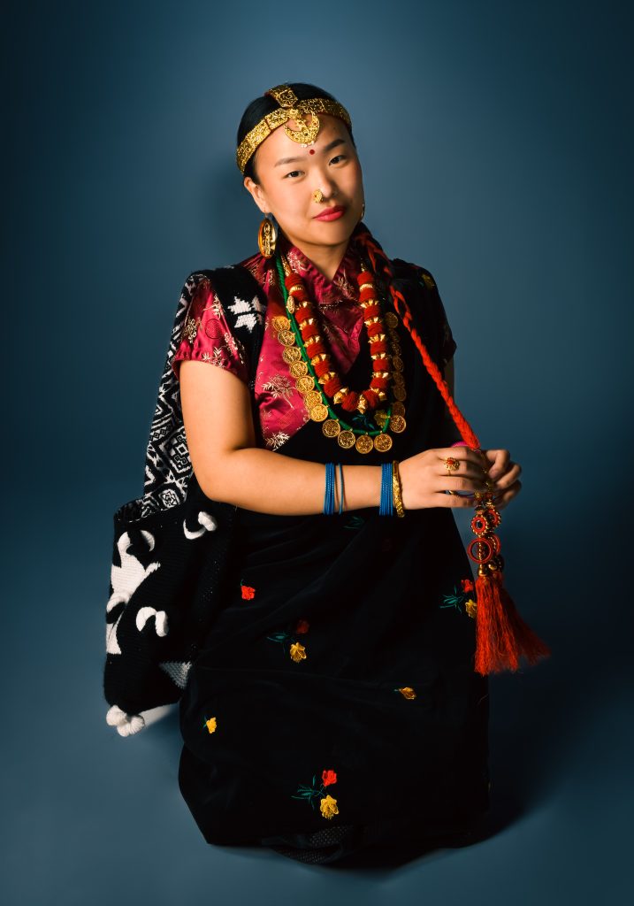 The purpose of this image is to show what women from Nepal traditionally wear on special occasions.